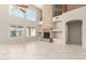 Open-concept living room showcasing a stone fireplace and large windows at 4801 E Quien Sabe Way, Cave Creek, AZ 85331