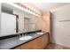 Bathroom with double sinks, wooden drawers and cabinet, and large mirror at 4808 N 24Th St # 702, Phoenix, AZ 85016