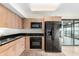 Kitchen featuring black appliances, granite counter tops, and wood cabinets at 4808 N 24Th St # 702, Phoenix, AZ 85016
