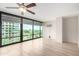 Bright living room with lots of natural light from the floor to ceiling windows, plus a ceiling fan at 4808 N 24Th St # 702, Phoenix, AZ 85016
