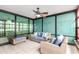 Enclosed sunroom features neutral tile flooring, wicker furniture, ceiling fan, and views from large pane windows at 4808 N 24Th St # 702, Phoenix, AZ 85016