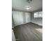 Bedroom featuring vinyl floors, sliding door closets, and a window at 500 N 67 Ave # 149, Phoenix, AZ 85043