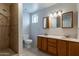 Tiled bathroom boasts a walk-in shower, dual sinks, and well-lit mirrors at 505 W Howe St, Tempe, AZ 85281