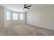 Spacious bedroom boasts carpet, ceiling fan and bay windows at 505 W Howe St, Tempe, AZ 85281