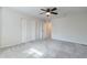 Spacious bedroom features a ceiling fan, carpet, closet, and entrance to hall at 505 W Howe St, Tempe, AZ 85281