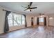 A bright living room with hardwood-style flooring, large windows, and ceiling fans at 505 W Howe St, Tempe, AZ 85281
