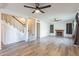 Open-concept living room features hardwood-style floors, a fireplace, and access to the stairs at 505 W Howe St, Tempe, AZ 85281