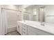A modern bathroom with double sinks, a tub and shower combo, and white subway tile surround at 5460 S Dillon Cir, Mesa, AZ 85212