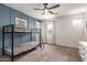 A bedroom with a bunkbed frame, neutral carpet and a decorative blue accent wall at 5460 S Dillon Cir, Mesa, AZ 85212