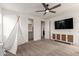This is a roomy bedroom featuring a fun teepee, a ceiling fan and a modern entertainment center at 5460 S Dillon Cir, Mesa, AZ 85212