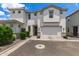Charming white two-story home featuring an attached two-car garage and beautiful front yard landscaping at 5460 S Dillon Cir, Mesa, AZ 85212