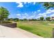 A lush green common area with clear blue skies offering residents community space at 5460 S Dillon Cir, Mesa, AZ 85212