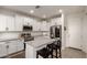 Modern kitchen featuring stainless steel appliances, white cabinets, and a center island with seating at 5460 S Dillon Cir, Mesa, AZ 85212