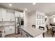 Bright kitchen with white cabinets, stainless steel appliances, and a large center island at 5460 S Dillon Cir, Mesa, AZ 85212