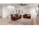 Bright living room featuring hardwood floors, two leather couches, and neutral walls at 5460 S Dillon Cir, Mesa, AZ 85212