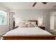 Bedroom featuring a woven headboard, side tables with lamps, and neutral bedding at 5460 S Dillon Cir, Mesa, AZ 85212