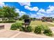 Park featuring a community grill on a sunny day with green grass and trees at 5460 S Dillon Cir, Mesa, AZ 85212
