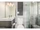 Modern bathroom featuring a floating vanity with sink and a glass-enclosed shower with tile surround at 5739 N 11Th St, Phoenix, AZ 85014