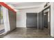 Minimalist bedroom with concrete floors, a brick accent wall, and contemporary gray doors at 5739 N 11Th St, Phoenix, AZ 85014