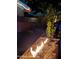 Backyard with an outdoor built-in gas fire feature set with a cactus and gravel at 5739 N 11Th St, Phoenix, AZ 85014