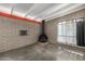 Living room view showcases concrete floors and modern fireplace with exposed ductwork at 5739 N 11Th St, Phoenix, AZ 85014