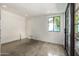 Sunlit room with concrete floors, window with view, and access to an outdoor space at 5739 N 11Th St, Phoenix, AZ 85014