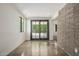 Open room featuring concrete floors, ample natural light from windows and large sliding door at 5739 N 11Th St, Phoenix, AZ 85014