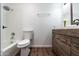 This bathroom includes a tub and shower, wood-grain vanity, and stylish fixtures at 6044 W Augusta Ave, Glendale, AZ 85301