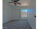 A comfortable bedroom with new carpet, a ceiling fan, and a window for natural light at 6044 W Augusta Ave, Glendale, AZ 85301