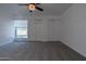 Bedroom with a ceiling fan, fresh carpet, a window with bars, and a double folding closet at 6044 W Augusta Ave, Glendale, AZ 85301