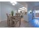 Dining area with wooden table and views into kitchen with stainless appliances at 6044 W Augusta Ave, Glendale, AZ 85301