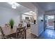 Dining area with views into kitchen with white cabinets and stainless appliances at 6044 W Augusta Ave, Glendale, AZ 85301