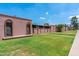 View of single-story home exteriors with well-manicured front lawns and arched entryways at 6044 W Augusta Ave, Glendale, AZ 85301