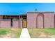 Single-story home with unique brickwork arch, decorative front gate, and desert landscaping at 6044 W Augusta Ave, Glendale, AZ 85301