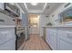 Modern kitchen with white cabinets, stainless steel appliances, and in-unit laundry at 6044 W Augusta Ave, Glendale, AZ 85301