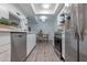 Stylish kitchen features stainless steel appliances, white cabinets, and adjacent dining area at 6044 W Augusta Ave, Glendale, AZ 85301