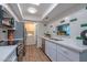 Updated kitchen features white cabinets, stainless steel appliances, and modern finishes at 6044 W Augusta Ave, Glendale, AZ 85301