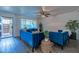 Bright living room with blue velvet furniture and wood-look flooring at 6044 W Augusta Ave, Glendale, AZ 85301