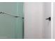 Shower detail displaying glass enclosure and brushed steel hardware in modern bathroom at 6044 W Augusta Ave, Glendale, AZ 85301