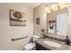 Cozy powder bathroom with granite countertop, framed mirror and neutral color scheme at 6133 E Saddleback St, Mesa, AZ 85215