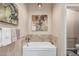 Clean bathtub with tiled backsplash and neutral color scheme at 6133 E Saddleback St, Mesa, AZ 85215