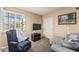 Cozy bedroom featuring a plush chair, mounted TV, and natural light streaming through shuttered windows at 6133 E Saddleback St, Mesa, AZ 85215