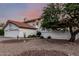 Home displaying desert landscaping, a tile roof, a two-story facade, and a three-car garage at 6133 E Saddleback St, Mesa, AZ 85215