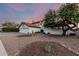 Two-story home showcasing desert landscaping, a tile roof, and a spacious three-car garage at 6133 E Saddleback St, Mesa, AZ 85215