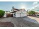 Two-story home featuring a two-car garage, desert landscaping, and a terra cotta tiled roof at 6133 E Saddleback St, Mesa, AZ 85215