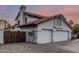 Charming house featuring a three-car garage and southwestern architecture, complemented by desert-style landscaping at 6133 E Saddleback St, Mesa, AZ 85215