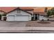Attractive home with a tile roof, three-car garage, and desert landscaping at 6133 E Saddleback St, Mesa, AZ 85215