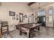 Spacious game room with high ceilings, wood-look tile flooring, and large front windows at 6133 E Saddleback St, Mesa, AZ 85215
