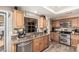 Bright kitchen featuring stainless steel appliances, granite countertops, and a modern sink at 6133 E Saddleback St, Mesa, AZ 85215