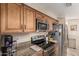 This kitchen features stainless steel appliances, granite countertops and wood cabinetry at 6133 E Saddleback St, Mesa, AZ 85215